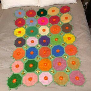 Crochet afghan with multicolored octagons and crewel blossoms